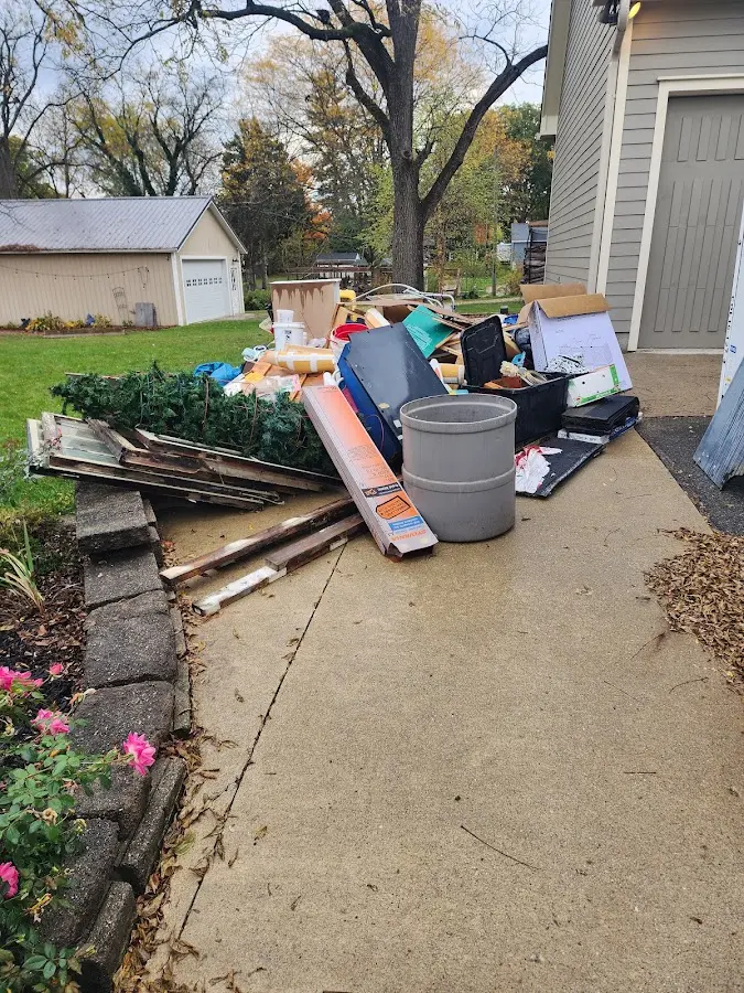 Dumpster being loaded with debris for Estate Cleanout Dumpster Rental in Brevard